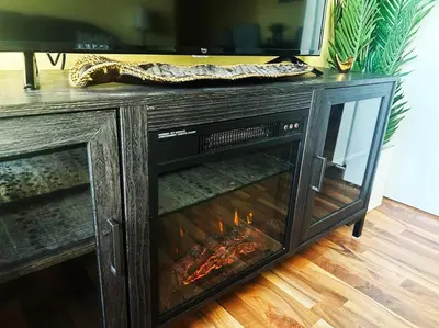 a fireplace in a entertainment center with a tv at 2 Full Beds, Rogers Place Downtown Central, Memorable 1 Bedroom Condo in Edmonton