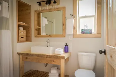 a bathroom with a sink and a toilet at Cabins West in Ucluelet