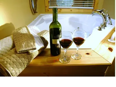 a bottle of wine and two glasses of wine at Cabins West in Ucluelet