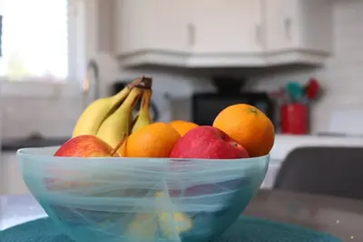 a bowl of fruit on a counter with bananas and oranges at Location, Location, Location-Immaculate 1 Bedroom Suite in Victoria