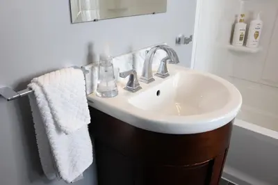 a bathroom with a white sink and a mirror at Location, Location, Location-Immaculate 1 Bedroom Suite in Victoria