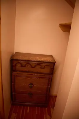 a wooden dresser in the corner of a room at Rustic Beaverfoot Lodge in Parson