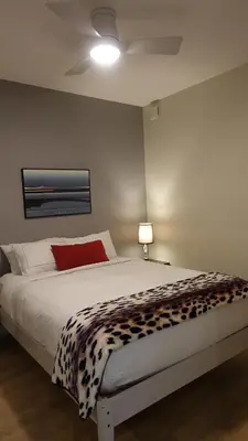 a bedroom with a bed with a cheetah blanket at Cityzen Sanctuary in Victoria