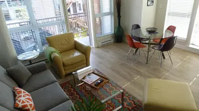 a living room with a couch and a table and chairs at Cityzen Sanctuary in Victoria