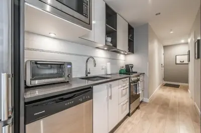a kitchen with a sink and a microwave at Cityzen Sanctuary in Victoria