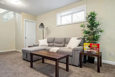 a living room with a couch and a coffee table at 5 Bedroom House in McConachie, Near Anthony Henday, Sleeps 12, Backyard, Netflix, Free Parking in Edmonton