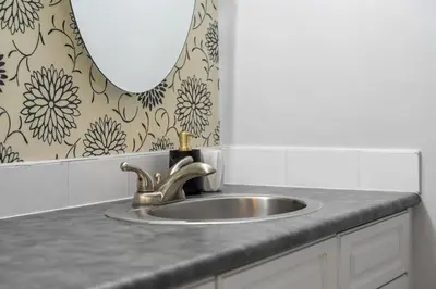 a bathroom sink with a mirror and a silver sink at Prime Location Near Jasper Ave with Downtown Views, Netflix, Gym, Sauna, Sleeps 4 in Edmonton