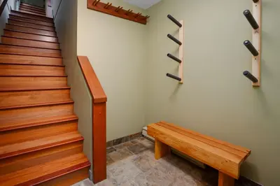 a staircase with a wooden bench and a stair case at 3BR in Wintergreen, Family Sized, Wood Burning Fireplace, Secure Parking, Ski Hill Bus Access in Whistler