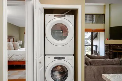 a washer and dryer in a living room at 3BR in Wintergreen, Family Sized, Wood Burning Fireplace, Secure Parking, Ski Hill Bus Access in Whistler