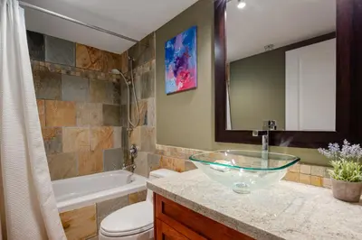 a bathroom with a bowl sink and a tub at 3BR in Wintergreen, Family Sized, Wood Burning Fireplace, Secure Parking, Ski Hill Bus Access in Whistler