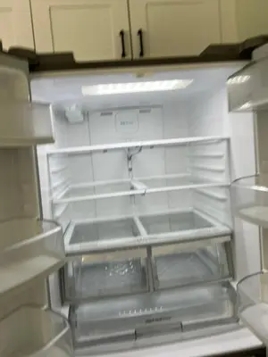 an empty refrigerator with its door open in a kitchen at Wellington House in Nanaimo