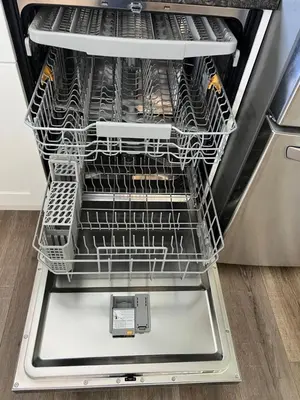 an empty dishwasher with its door open with dishes in it at Wellington House in Nanaimo