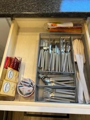 a drawer filled with silver utensils in a cabinet at Wellington House in Nanaimo