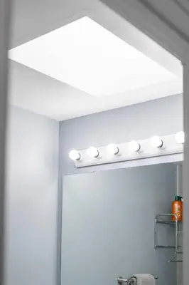a bathroom with a white ceiling with a row of lights at Comfy Getaway - Walk to West Ed Mall in Edmonton
