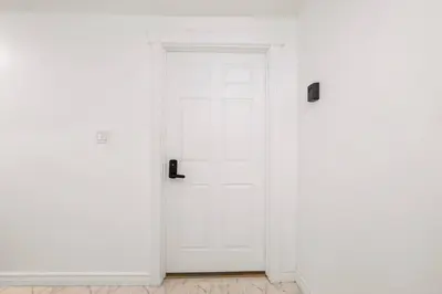 a white door in a room with white walls at Cozy Suite - Walk to West Ed Mall in Edmonton