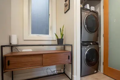 a laundry room with a washer and dryer at 1BR plus Two Dens in The Gables, Epic Location Near Gondolas, Private Balcony, Fireplace, Parking in Whistler