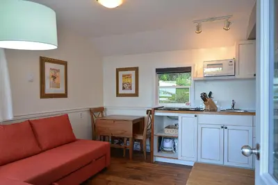 a kitchen with a couch and a table in a room at John Henry's Marina and Resort in Garden Bay