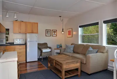 a living room with a couch and a kitchen at John Henry's Marina and Resort in Garden Bay