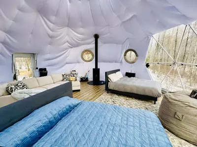 a living room with a bed and a tent at Refuge Bay's Aer XL Dome Luxury Off Grid Escape in Cherhill