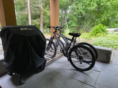 a bike parked next to a porch with a cover on it at Cozy Townhouse in Whistler Village North in Whistler