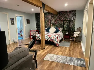 a bedroom with a bed and a couch in a room at Along the Way in Youbou