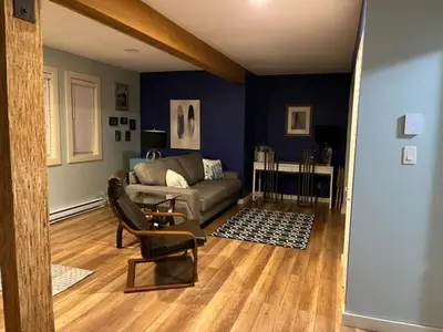 a living room with a couch and a chair at Along the Way in Youbou