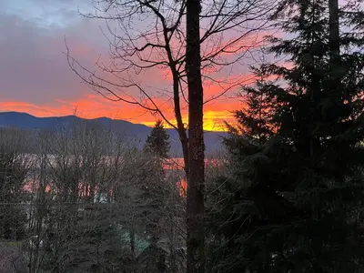 a sunset view from the window of a house at Along the Way in Youbou