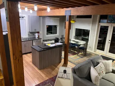 a kitchen and living room with a couch and a table at Along the Way in Youbou