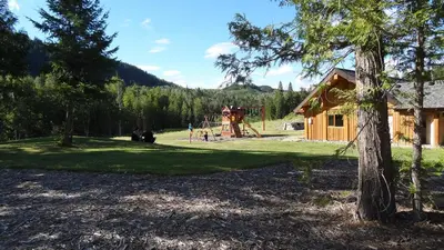 a park with a playground and a house at Alpine Meadows Resort in Clearwater