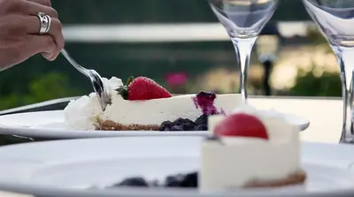 a person eating a piece of cake with a fork at Alpine Meadows Resort in Clearwater