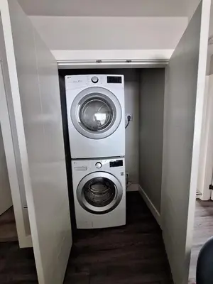 a washer and dryer in a small room at Two Bedroom Suite with AC, Sleeps 8- Welcome Snacks and Drinks Included in Langford