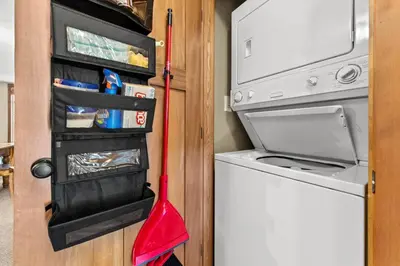 a kitchen with a washing machine and a red mop at Settlers Crossing #35 condo in Sun Peaks