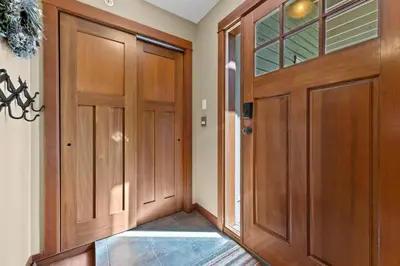 a hallway with wooden doors and a tile floor at Settlers Crossing #35 condo in Sun Peaks