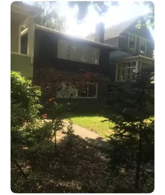 a black house with a window and a yard at Quiet-comfy 4 bedroom house on a quiet tree lined street in Kitsilano in Vancouver