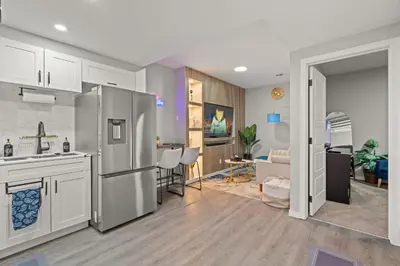 a kitchen and living room with a stainless steel refrigerator at Meriweather - Calgary Breathtaking 1-bedroom apartment in Calgary