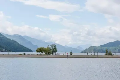 a large body of water with mountains in the background at New 1 Bed Condo with Mtn Views in Harrison Hot Springs