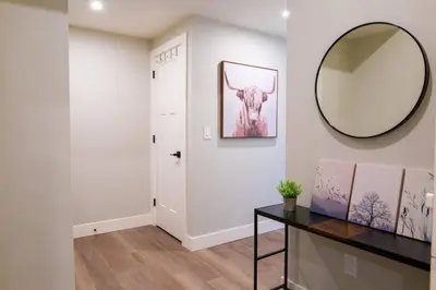 a hallway with a mirror on the wall and a desk at New 1 Bed Condo with Mtn Views in Harrison Hot Springs