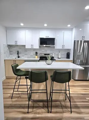 a kitchen with a white table and four chairs at Cozy 2 bedrooms and 1 bath for 4 guests! in Calgary