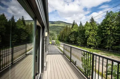 a balcony of a house with a view of a road at L'Austin Rêve by Revelstoke Vacations in Revelstoke