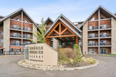 a sign in front of a building at Cozy One Bedroom Condo with Indoor Pool and HotTub in Canmore
