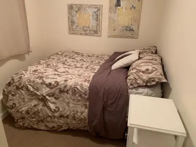 a small bed in a corner of a room at fabulous beach side apartment in Vancouver