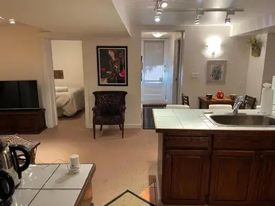 a kitchen with a sink and a living room at fabulous beach side apartment in Vancouver