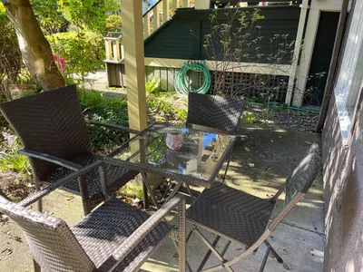 two chairs and a glass table on a patio at fabulous beach side apartment in Vancouver
