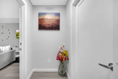 a vase filled with flowers sitting in a room at Modern & Spacious Guest Suite in Calgary