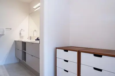 a bathroom with a sink and a wooden table at Drop in Condo by Revelstoke Vacations in Revelstoke