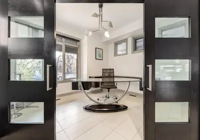 an office with a glass table and a chair at Newly Renovated Vacation Home w/ Hot Tub & Garage in Calgary