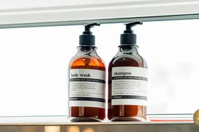 two bottles of alcohol sitting on a shelf at Modern Luxury Home - King Bed•Arcade•WEM•A/C in Edmonton