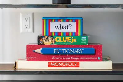 a stack of books sitting on a shelf at Modern Luxury Home - King Bed•Arcade•WEM•A/C in Edmonton