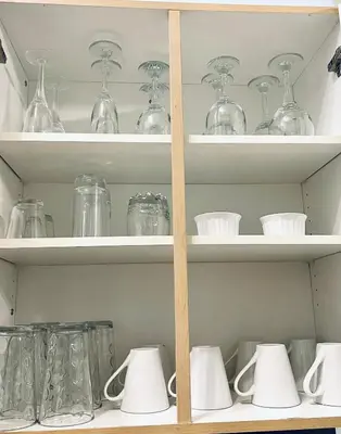 a shelf full of glass jars and vases at Modern Upper Level Duplex House in Slave Lake