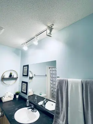 a bathroom with a sink and a mirror at Modern Upper Level Duplex House in Slave Lake